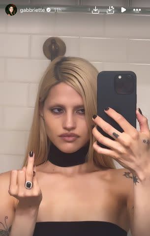 <p>Gabbriette Bechtel/Instagram</p> Gabbriette Bechtel flips off camera with new engagement ring