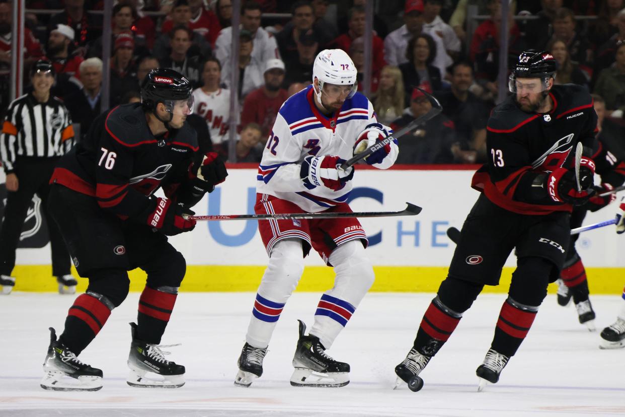 RALEIGH, NORTH CAROLINA - MAY 09: Filip Chytil #72 of the New York Rangers skates between Brady Skjei #76 and Stefan Noesen #23 of the Carolina Hurricanes during the first period in Game Three of the Second Round of the 2024 Stanley Cup Playoffs at PNC Arena on May 09, 2024 in Raleigh, North Carolina.