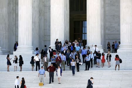 Court observers and attorneys depart after decisions were handed down on the last day of the term at the U.S. Supreme Court building in Washington June 29, 2015. REUTERS/Jonathan Ernst