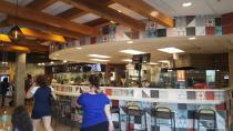 <p>A huge counter features stools where you can sit and watch workers prepare food. </p>