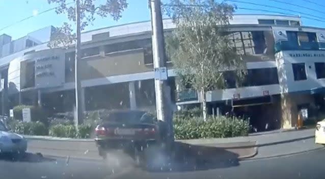 The rear dashcam then shows the car flying over and narrowly missing a pole. Photo: Facebook/ Dash Cam Owners Australia