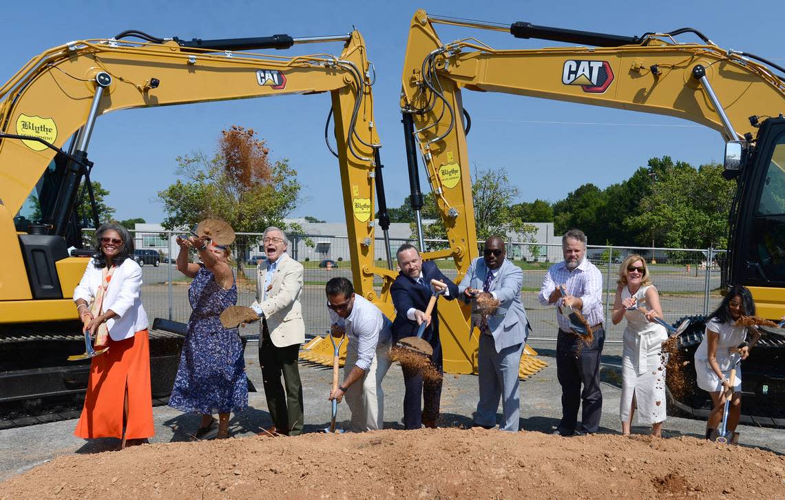 Charlotte City Council members toss dirt into the air Wednesday to mark the start of construction on Eastland Yards. The $175 million project will transform the old Eastland Mall site into a mixed-use development.