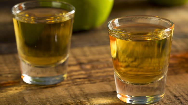 Two shot glasses of apple whiskey