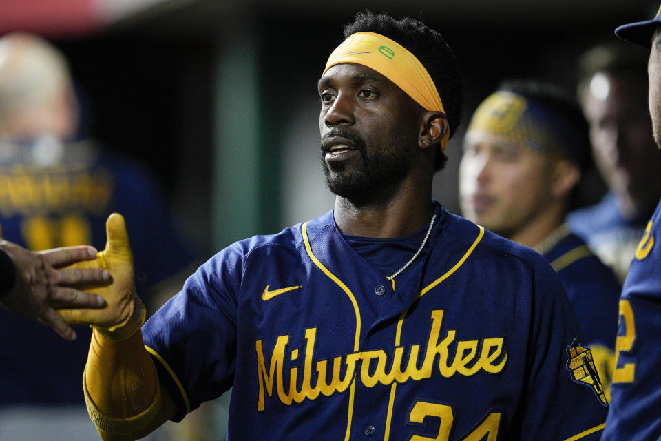 Milwaukee Brewers' Andrew McCutchen (24) celebrates with teammates after scoring on an Omar Narvaez single during the fourth inning of a baseball game against the Cincinnati Reds, Saturday, Sept. 24, 2022, in Cincinnati. (AP Photo/Jeff Dean)