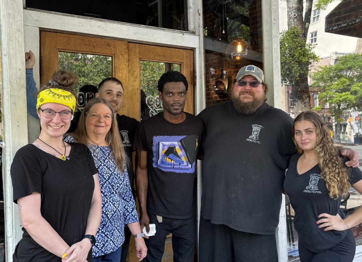 Katie Honaker, Diane Smith, Ellis McNeill, John Biggett, Dustin Smith and Kaitlyn Thompson stand outside Fork n Cork restaurant at 122 Market St. in Wilmington, N.C.