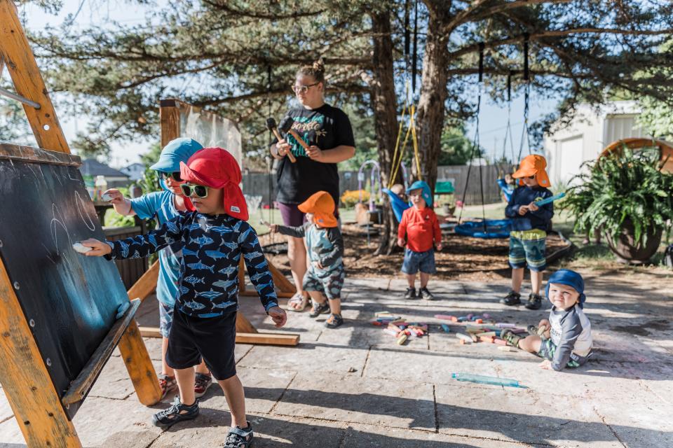 Children enjoy playing in the backyard classroom at Explorations Child Care under the watchful eye of Sydney Hallett last year.