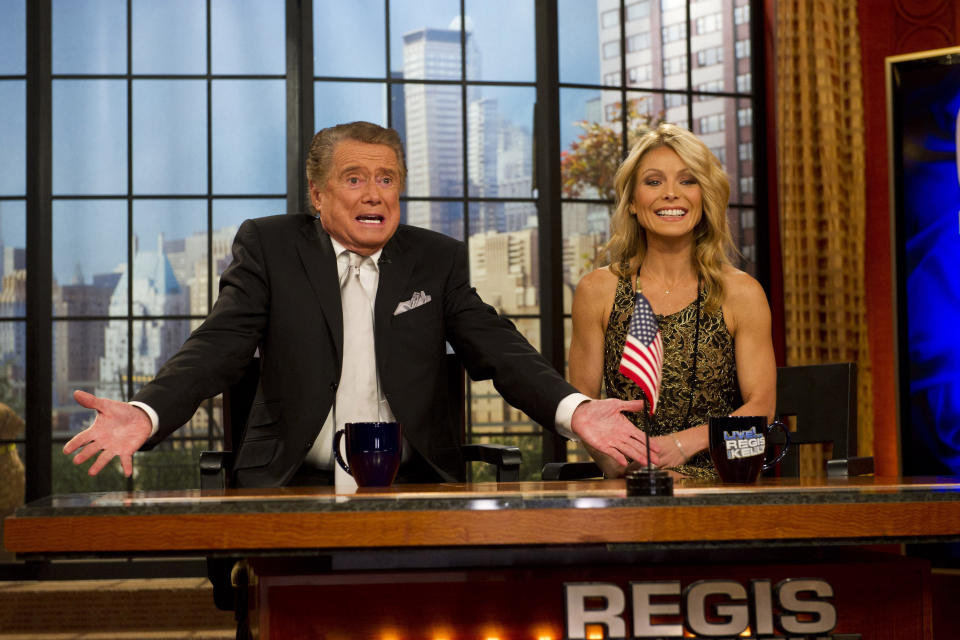 FILE - In this Nov. 18, 2011 file photo, Regis Philbin and Kelly Ripa appear on Regis' farewell episode of "Live! with Regis and Kelly", in New York. Philbin, the genial host who shared his life with television viewers over morning coffee for decades and helped himself and some fans strike it rich with the game show “Who Wants to Be a Millionaire,” has died on Friday, July 24, 2020. (AP Photo/Charles Sykes, File)