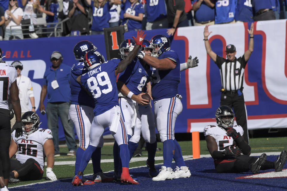 New York Giants quarterback Daniel Jones (8) celebrates with his teammates after scoring a two-point conversion during the second half of an NFL football game against the Atlanta Falcons, Sunday, Sept. 26, 2021, in East Rutherford, N.J. (AP Photo/Bill Kostroun)