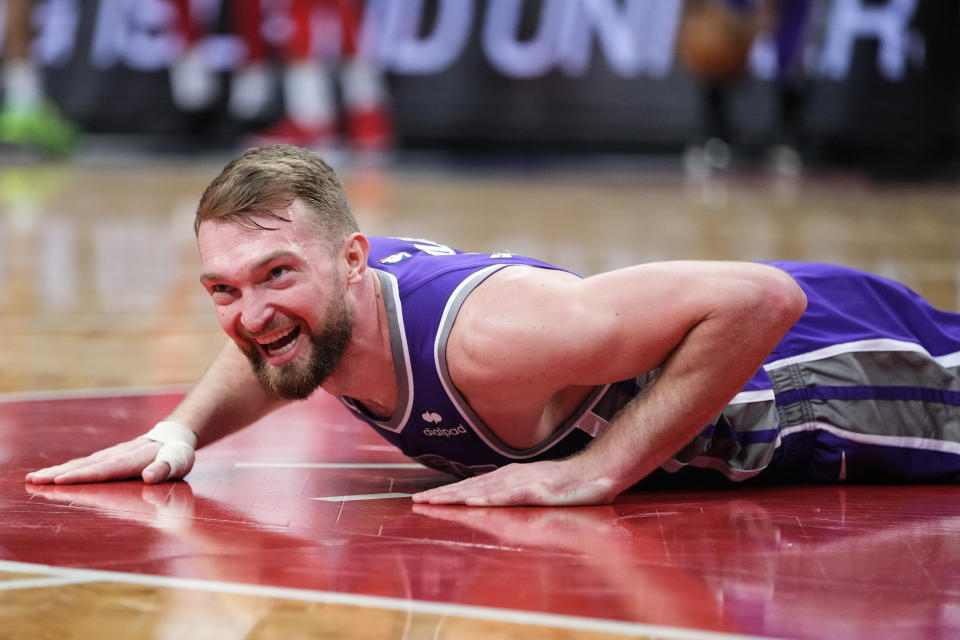 Sacramento Kings' Domantas Sabonis smiles after falling down during the first half of the team's NBA basketball game against the Brooklyn Nets on Thursday, March 16, 2023, in New York. (AP Photo/Frank Franklin II)