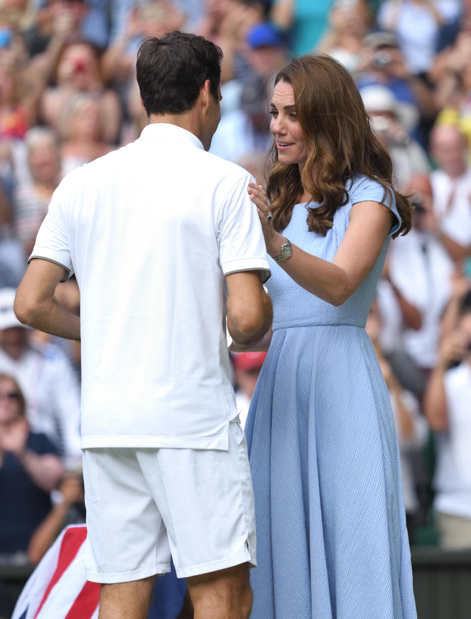 LONDON, ENGLAND - JULY 14: Roger Federer of Switzerland is presented with the runners-up trophy by Catherine, Duchess of Cambridge after his Men's Singles final against Novak Djokovic of Serbia during Day thirteen of the Wimbledon Tennis Championships at All England Lawn Tennis and Croquet Club on July 14, 2019 in London, England. (Photo by Karwai Tang/Getty Images)