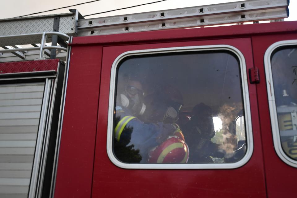 Firefighters prepare to during a wildfire in Kryoneri area, northern Athens, Greece, Thursday, Aug. 5, 2021. Wildfires rekindled outside Athens and forced more evacuations around southern Greece Thursday as weather conditions worsened and firefighters in a round-the-clock battle stopped the flames just outside the birthplace of the ancient Olympics. (AP Photo/Michael Varaklas)