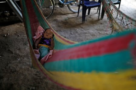 A girl rests in a hammock during a temporary state of siege, approved by the Guatemalan Congress following the death of several soldiers last week, in the community of Semuy II, Izabal province