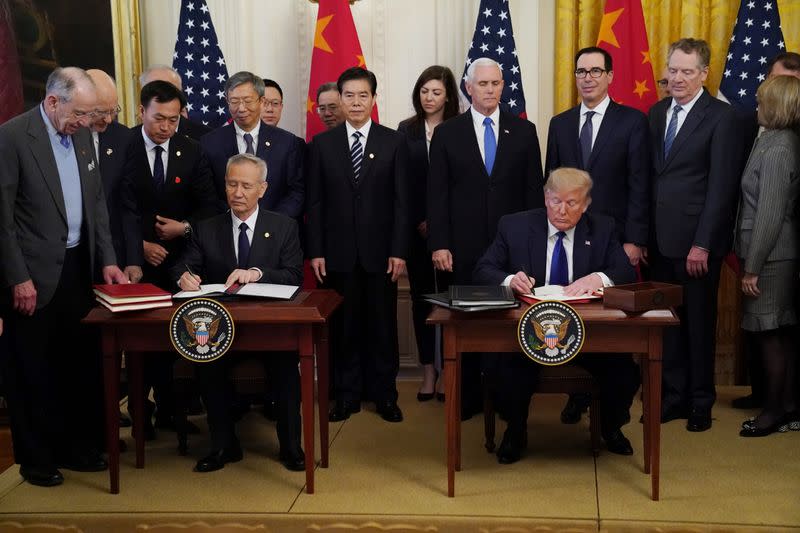 Chinese Vice Premier Liu He and U.S. President Donald Trump sign "phase one" of the U.S.-China trade agreement at the White House in Washington
