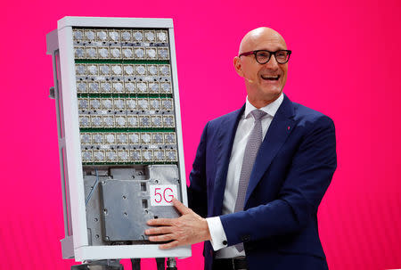 Timotheus Hoettges, CEO of Deutsche Telekom AG, stands in front of a 5G antenna of Swedish network infrastructure providerÊEricsson during the company's annual shareholder meeting in Bonn, Germany March 28, 2019. REUTERS/Wolfgang Rattay