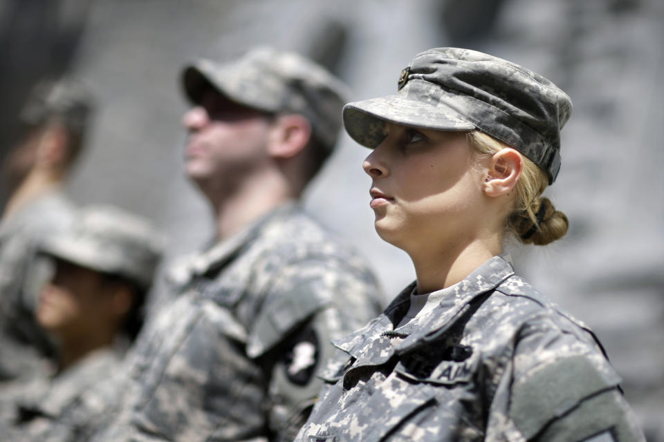 In this April 9, 2014 photo, West Point cadet Austen Boroff, right, of Chatham, N.J., stands in formation with others, as she waits to march to lunch at the United States Military Academy in West Point, N.Y. With the Pentagon lifting restrictions for women in combat jobs, Lt. Gen. Robert Caslen Jr. has set a goal of boosting the number of women above 20 percent for the new class reporting this summer. (AP Photo/Mel Evans)