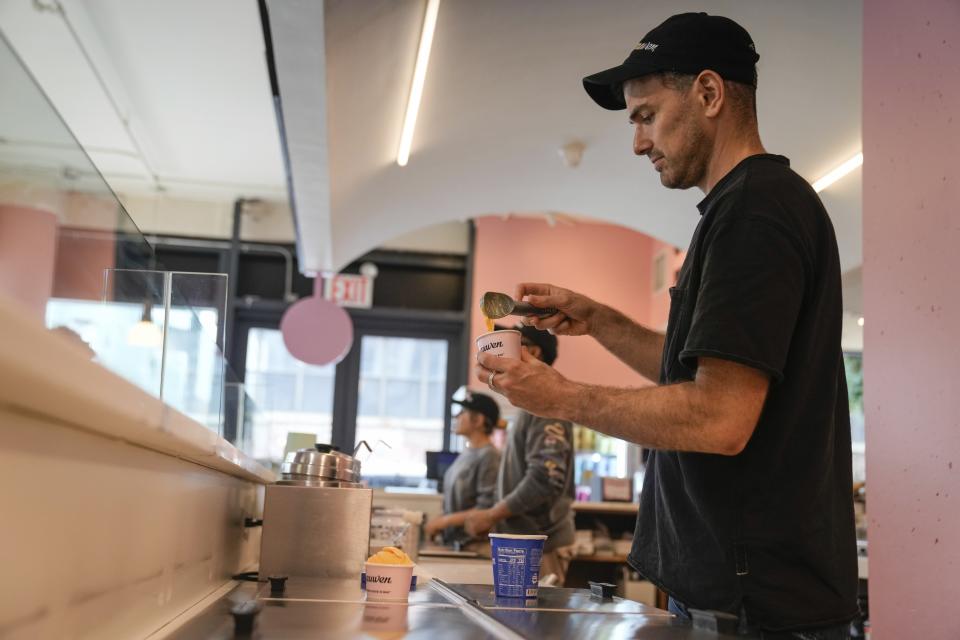 Ben Van Leeuwen scoops Kraft Mac & Cheese flavored ice cream Wednesday, May 15, 2024, in the Brooklyn borough of New York. Kraft Heinz approached New York-based artisanal ice cream maker Van Leeuwen a few years ago about macaroni and cheese-flavored ice cream. (AP Photo/Frank Franklin II)