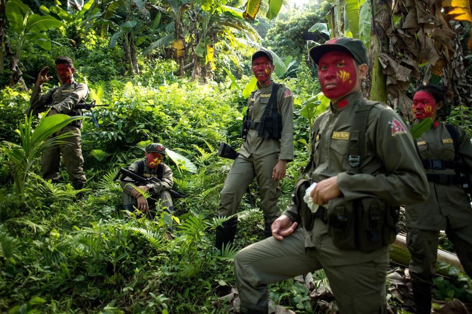 FILE PHOTO: This photo taken on July 30, 2017 shows guerrillas of the New People's Army (NPA) resting among bushes in the Sierra Madre mountain range, located east of Manila. (Photo: NOEL CELIS/AFP via Getty Images)