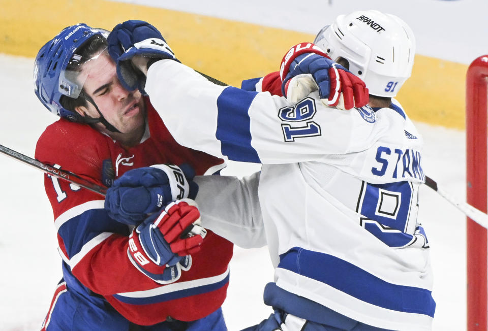 Montreal Canadiens' Alex Newhook, left, and Tampa Bay Lightning's Steven Stamkos, right, scuffle during first-period NHL hockey game action in Montreal, Thursday, April 4, 2024. (Graham Hughes/The Canadian Press via AP)