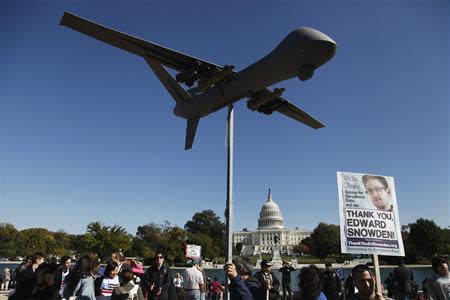 Demonstrators deploy a model of a U.S. drone aircraft at the "Stop Watching Us: A Rally Against Mass Surveillance" near the U.S. Capitol in Washington, October 26, 2013. REUTERS/Jonathan Ernst