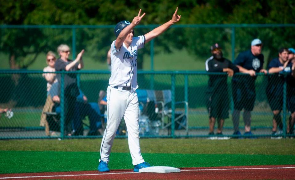 Olympia’s Sax Matson celebrates teammate Gabe Downing’s ground-rule double during the Bears 6-0 victory over Issaquah in the quarterfinal round of the 4A state baseball tournament at the Regional Athletic Complex in Lacey, Washington, on Saturday, May 22, 2022.