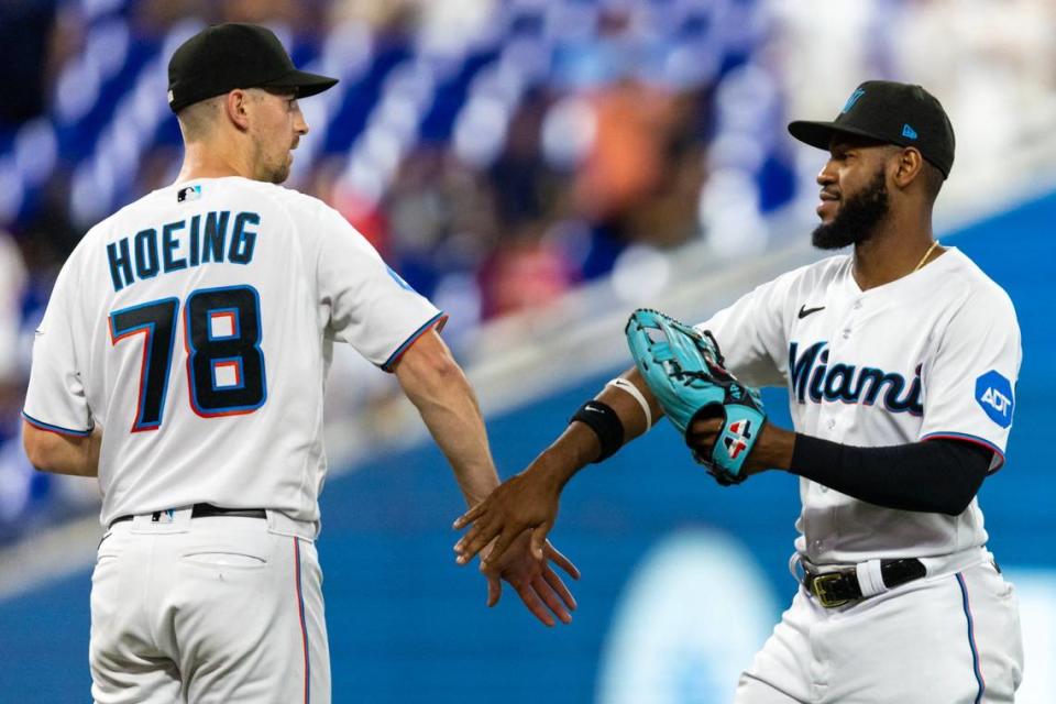 Miami Marlins closing pitcher Bryan Hoeing (78) reacts with teammate Bryan De La Cruz (14) after defeating the Kansas City Royal 6-1 in nine innings of an MLB game at loanDepot park in the Little Havana neighborhood of Miami, Florida, on Tuesday, June 6, 2023.