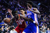 Atlanta Hawks' Clint Capela, left, tries to get past Philadelphia 76ers' Joel Embiid during the first half of an NBA basketball game, Saturday, Oct. 30, 2021, in Philadelphia. (AP Photo/Matt Slocum)