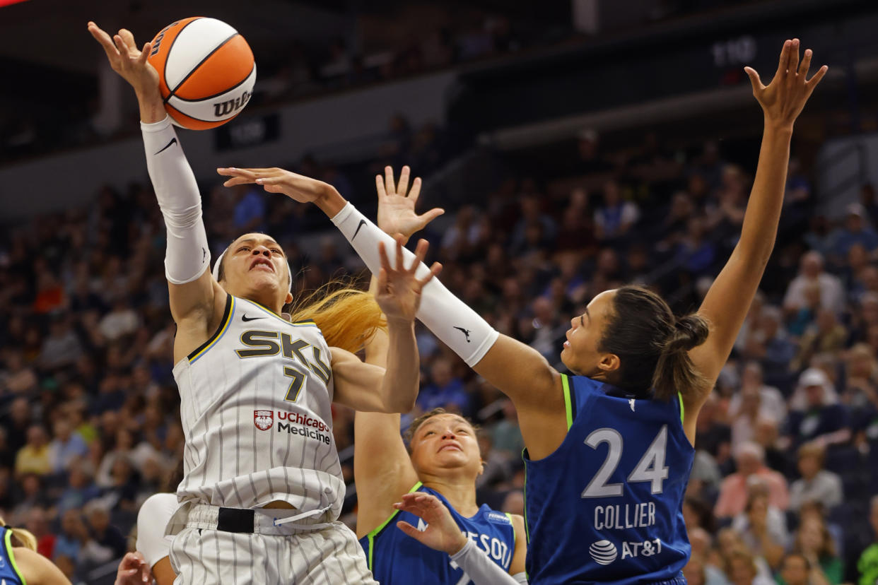 Chicago Sky guard Chennedy Carter (7) goes to the basket as Minnesota Lynx guard Kayla McBride, center, and forward Napheesa Collier (24) guard against her in the third quarter of a WNBA basketball game Friday, Sept. 13, 2024, in Minneapolis. (AP Photo/Bruce Kluckhohn)