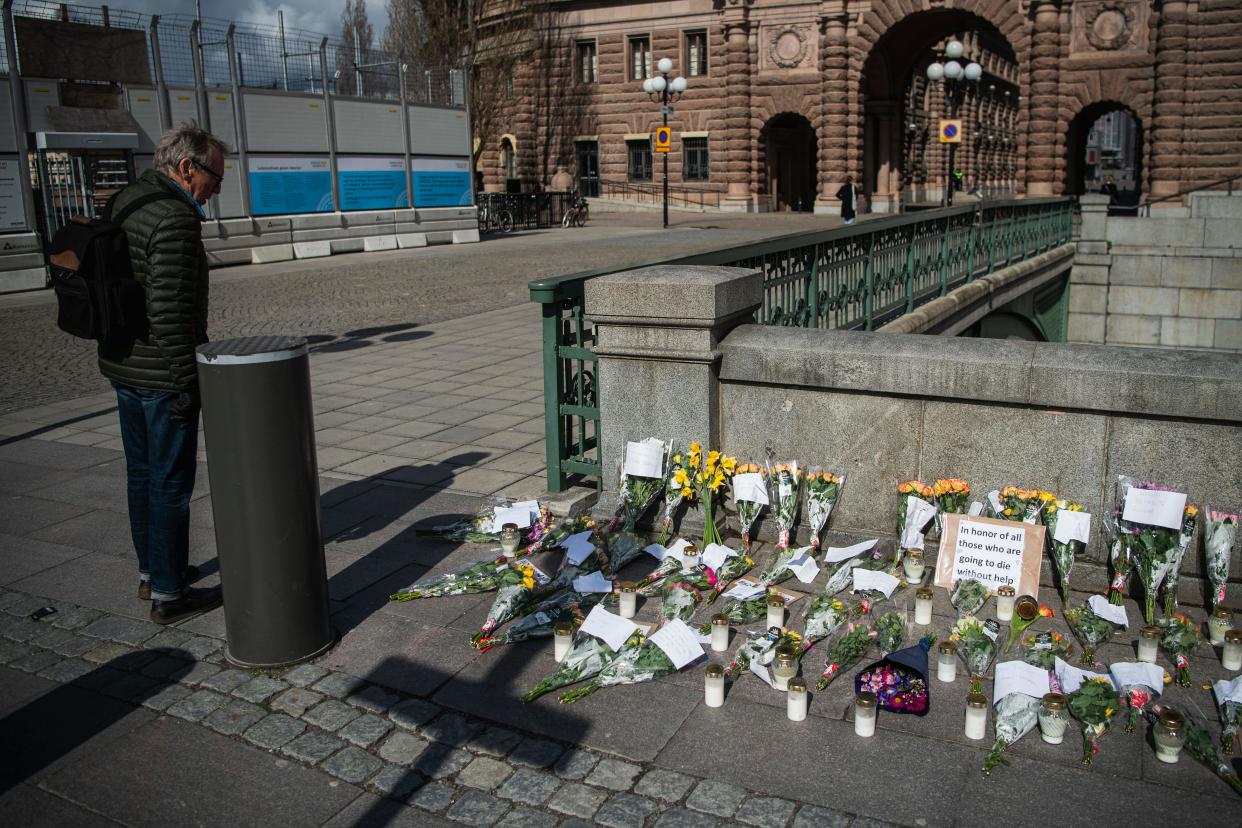 Picture taken on April 29, 2020 shows a memorial in Stockholm's Mynttorget square in memory of loved ones lost to the new coronavirus featuring candles, flowers and handwritten notes, some of which express frustration over Sweden's softer approach to curbing the illness. (Photo by Jonathan NACKSTRAND / AFP) (Photo by JONATHAN NACKSTRAND/AFP via Getty Images)