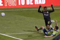 Seattle Sounders' Shane O'Neill, bottom, trips Columbus Crew's Luis Diaz during the first half of the MLS Cup championship soccer match Saturday, Dec. 12, 2020, in Columbus, Ohio. O'Neill was called for tripping on the play. (AP Photo/Jay LaPrete)