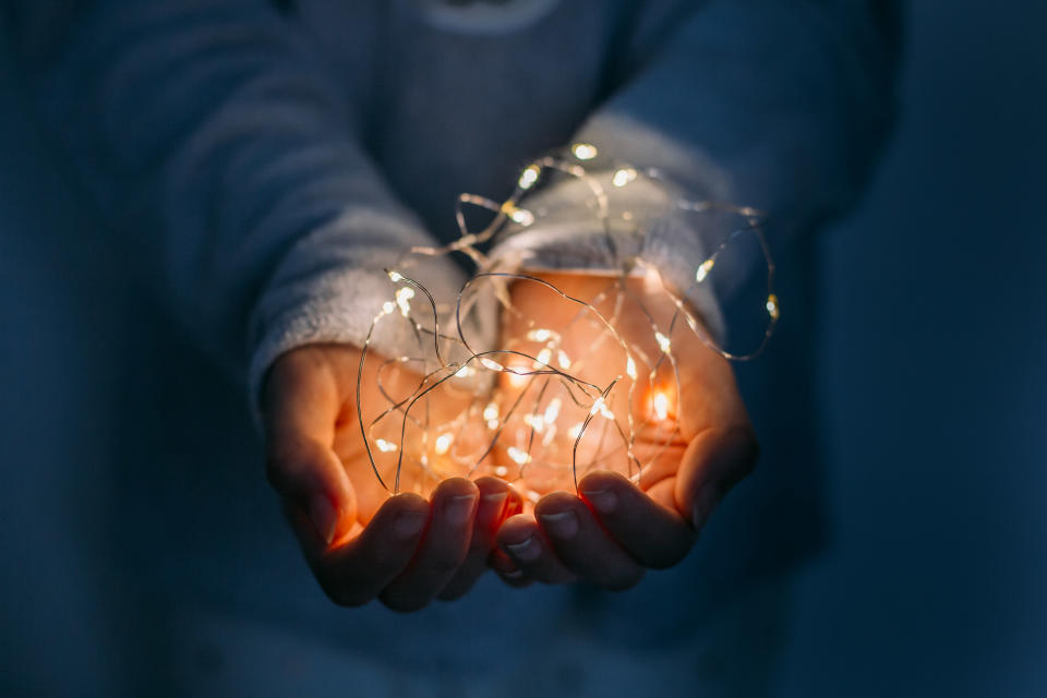 A hand with fairy lights