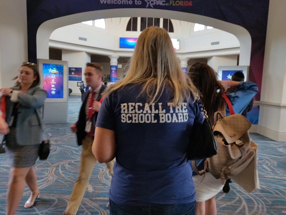 CPAC attendee wears a T-shirt that reads, "Recall the school board."