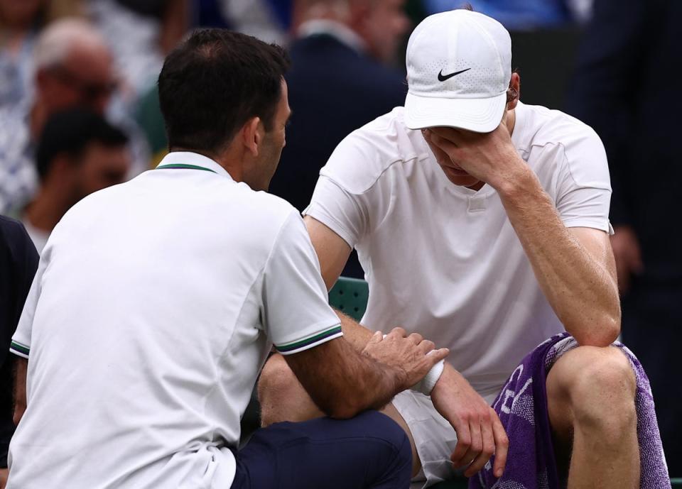 Jannik Sinner needed treatment as he struggled on Centre Court (AFP via Getty Images)