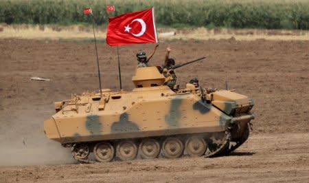 Turkish armoured personnel carriers (APC) maneuver during a military exercise near the Turkish-Iraqi border in Silopi, Turkey September 26, 2017. REUTERS/Umit Bektas