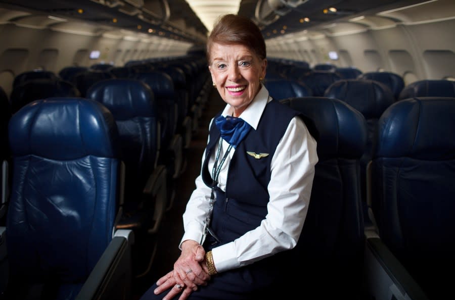 FILE – Flight attendant Bette Nash poses on a plane at Logan International Airport in Boston on Dec. 18, 2014. Nash, who was once named the world’s longest-serving flight attendant, has died. She was 88. American Airlines, Nash’s employer, announced her passing on social media Saturday. (AP Photo Dina Rudick/Boston Globe via AP, File)