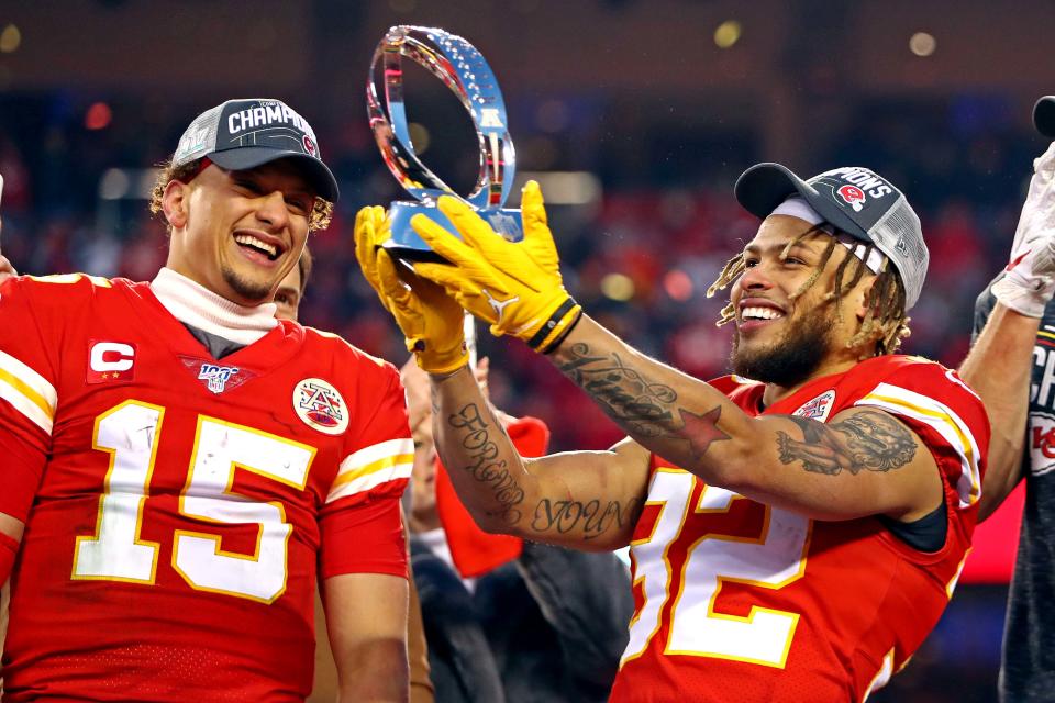 Kansas City Chiefs quarterback Patrick Mahomes (15) and strong safety Tyrann Mathieu (32) celebrate with the Lamar Hunt Trophy after beating the Tennessee Titans in the AFC Championship Game at Arrowhead Stadium on Jan. 19.