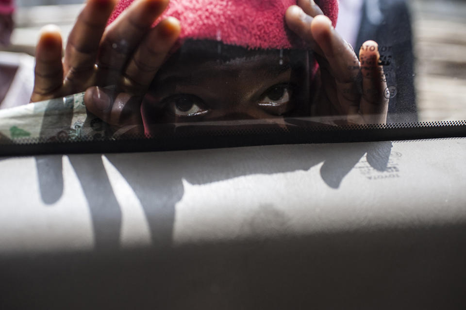 Child looking through window