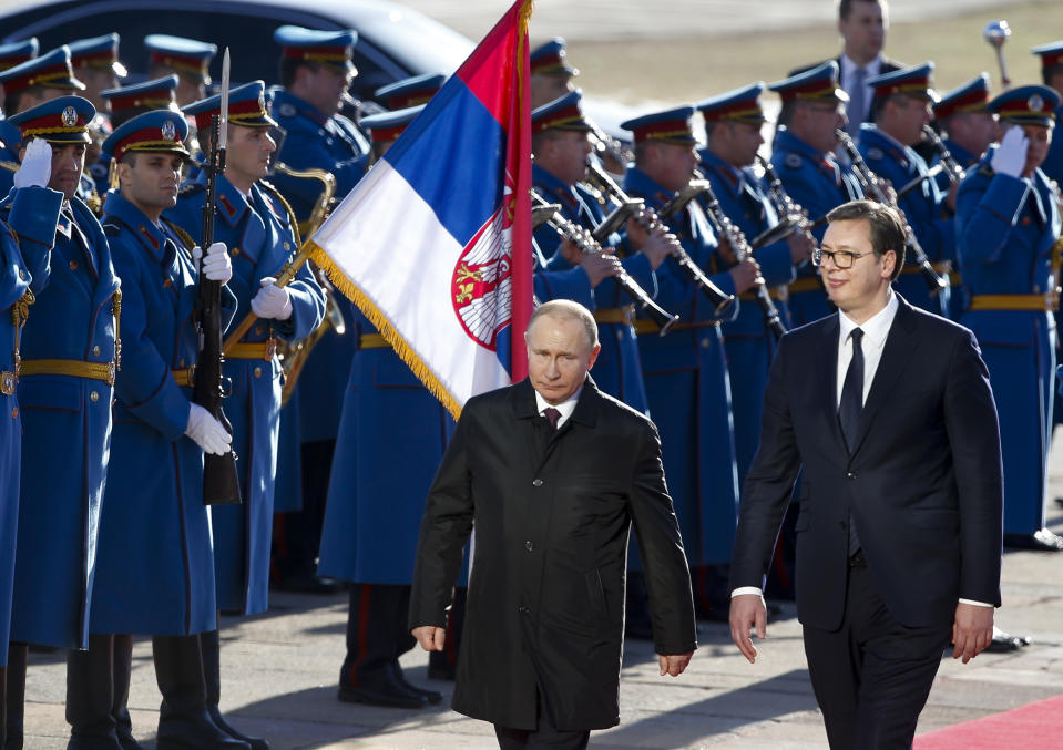 Serbian President Aleksandar Vucic, right, and Russian President Vladimir Putin, center, attend an official welcome ceremony prior to their talks in Belgrade, Serbia, Thursday, Jan. 17, 2019. Putin arrives in Serbia on Thursday for his fourth visit to the Balkan country since 2001. (AP Photo/Darko Vojinovic)