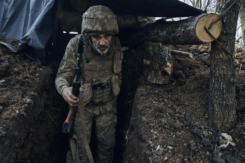 A Ukrainian soldier of the 28th brigade leaves a shelter on the frontline during a battle with Russian troops near Bakhmut, Donetsk region, Ukraine, Friday, March 24, 2023. (AP Photo/Libkos)