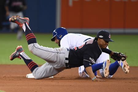 Oct 17, 2016; Toronto, Ontario, CAN; Toronto Blue Jays center fielder Kevin Pillar (back) steals second base against Cleveland Indians shortstop Francisco Lindor (front) during the seventh inning in game three of the 2016 ALCS playoff baseball series at Rogers Centre. Mandatory Credit: Nick Turchiaro-USA TODAY Sports