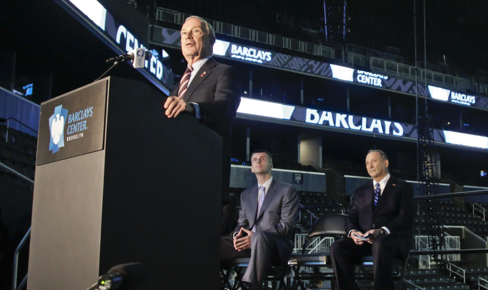 New York Mayor Michael Bloomberg speaks during a a ribbon cutting ceremony at Brooklyn's Barclays Center on Friday, Sept. 21, 2012, as Brooklyn Nets owner Mikhail Prokhorov, center, and Forest City Ratner Companies Chairman and CEO Bruce Ratner, right, look on. After decades without a professional sports team, New York City's ascendant borough hit the major leagues again on Friday with the opening of the Brooklyn Nets' new arena. (AP Photo/Bebeto Matthews)