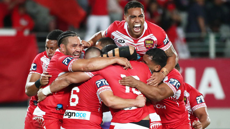 Pictured here, Tongan players celebrate after beating Australia in a 2019 rugby league Test match.