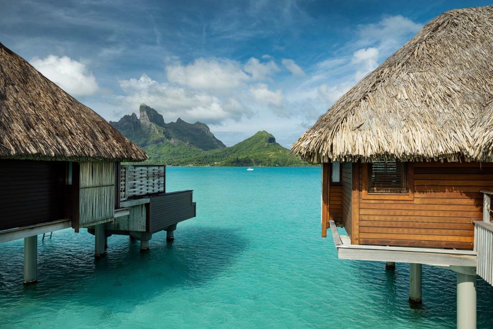 a couple of buildings on a dock over a body of water