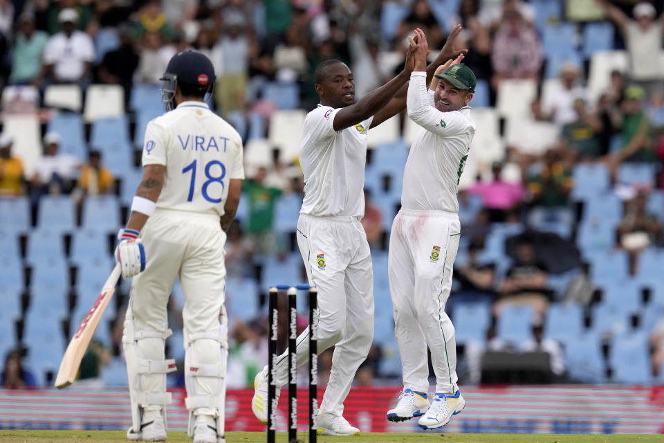South Africa's bowler Kagiso Rabada, centre, celebrates with teammate Dean Elgar after dismissing India's batsman Virat Kohli for 38 runs during the first day of the Test cricket match between South Africa and India, at Centurion Park, South Africa, Tuesday, Dec. 26, 2023. (AP Photo/Themba Hadebe)