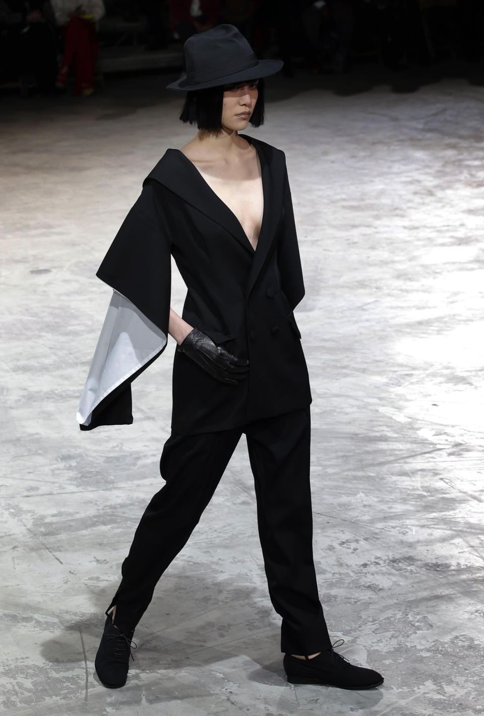 A model wears a creation by Japanese fashion designer Yohji Yamamoto for his Fall/Winter 2013-2014 ready to wear collection, in Paris, Friday, March 1, 2013. (AP Photo/Christophe Ena)