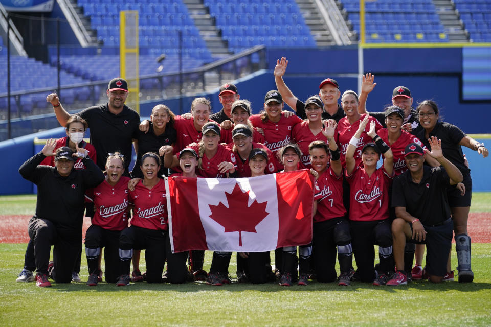 Members of team Canada pose for photographs after a softball game against Mexico at the 2020 Summer Olympics, Tuesday, July 27, 2021, in Yokohama, Japan. Canada won 3-2. (AP Photo/Sue Ogrocki)