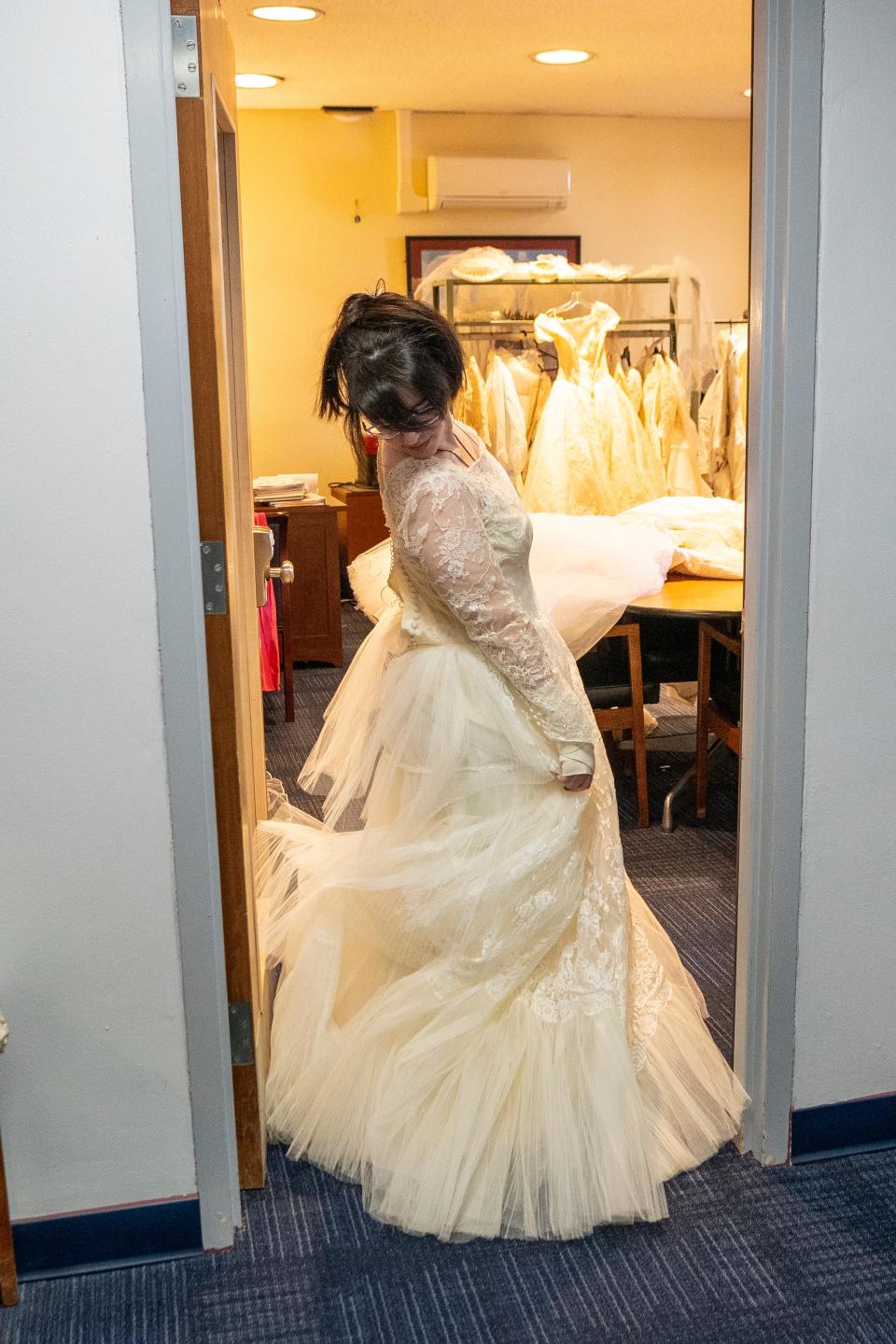 Apr 4, 2024; Fair Lawn, NJ, United States; The Maurice M. Pine Free Public Library has a lending library of wedding dresses. Samantha Sadkin gives a twirl as she tries on a wedding dress.