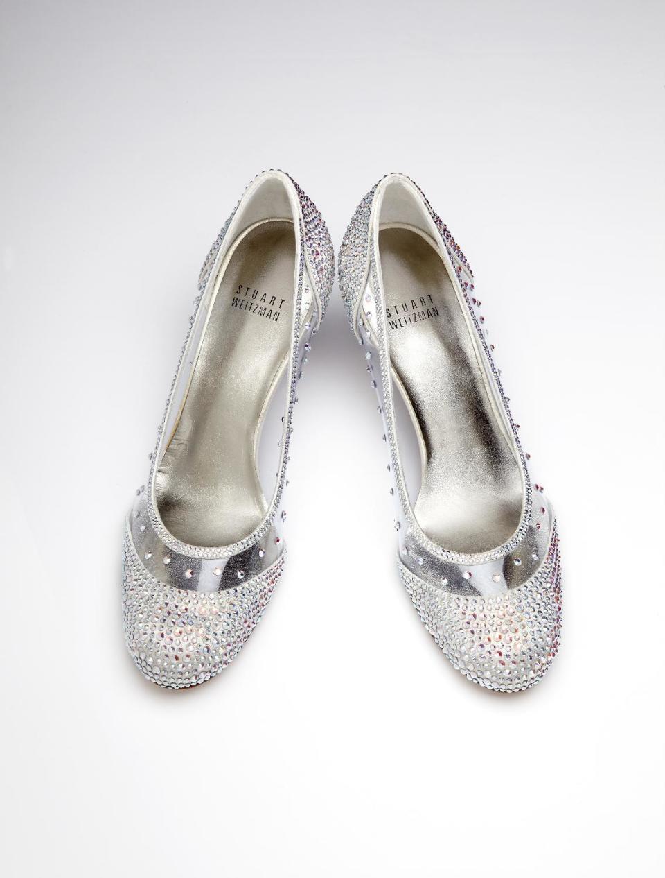 This image released by Stuart Weitzman shows a pair of glass slippers designed by Stuart Weitzman that will be worn by actress Laura Osnes in the title role of the Broadway musical, "Rodgers + Hammerstein's Cinderella on Broadway." Weitzman knows how to make shoes that make a splash. For years, he made the “million-dollar Oscar shoes,” diamond-covered footwear that a celebrity would wear to the Academy Awards. He employed a welded-construction technique that uses no screws so that Cinderella could have a seamless look. (AP Photo/Stuart Weitzman )