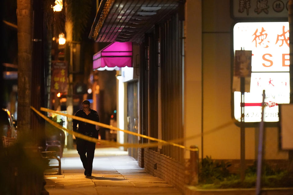 A police officer walks near a scene where a shooting took place in Monterey Park, Calif., Sunday, Jan. 22, 2023. Nine people were killed in a mass shooting late Saturday in a city east of Los Angeles following a Lunar New Year celebration that attracted thousands, police said. (AP Photo/Jae C. Hong)