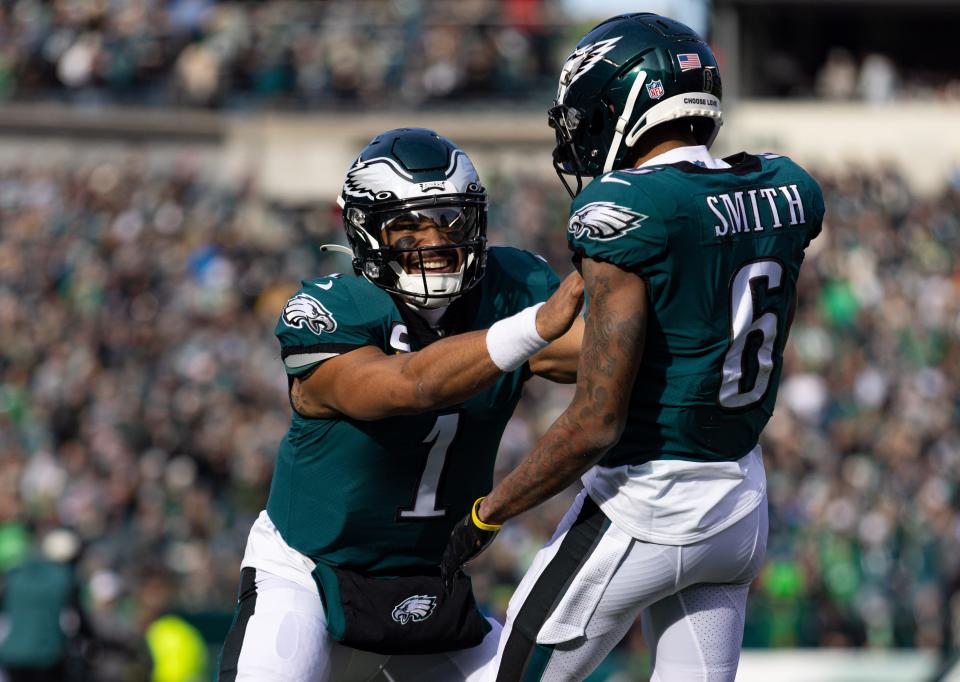 Eagles quarterback Jalen Hurts (1) and wide receiver DeVonta Smith (6) celebrate a touchdown against the Titans during the first quarter at Lincoln Financial Field.