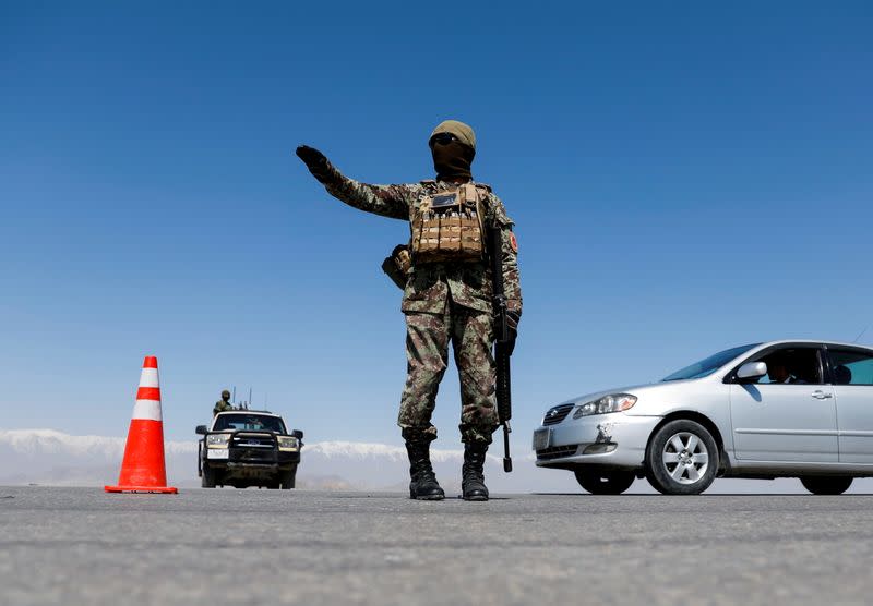 FILE PHOTO: An Afghan National Army soldier stands guard at a checkpoint on the outskirts of Kabul